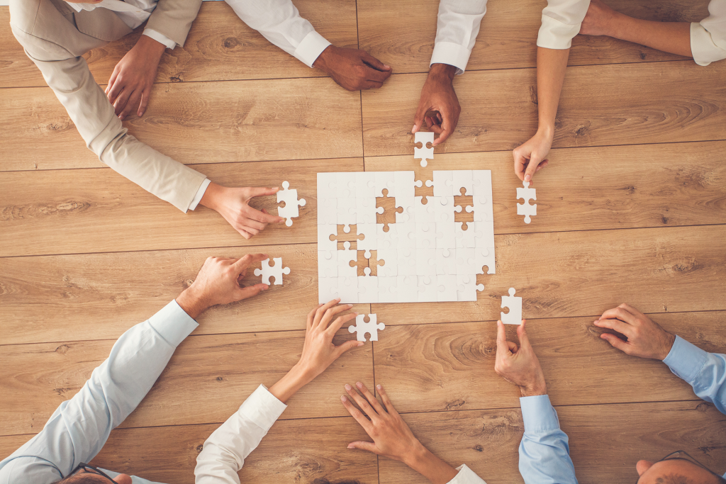 a team putting pieces into a puzzle